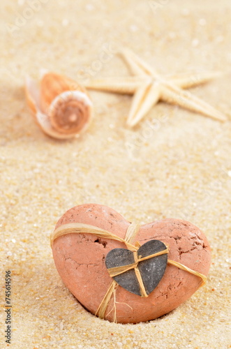 Sand with shells and heart. Summer background, for love. 