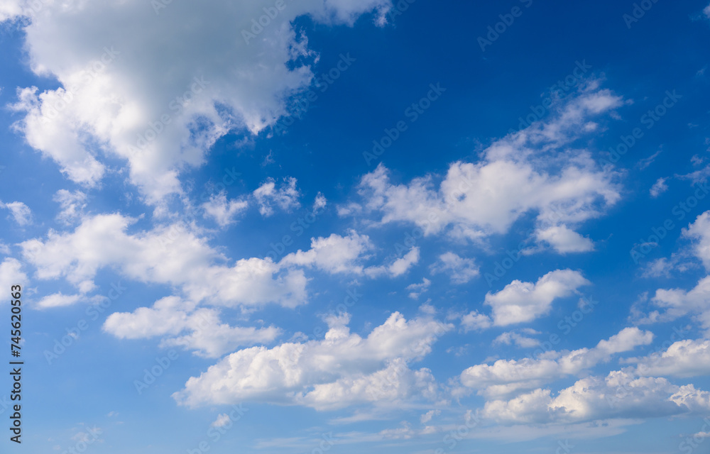 Blue sky nature background with fluffy white clouds
