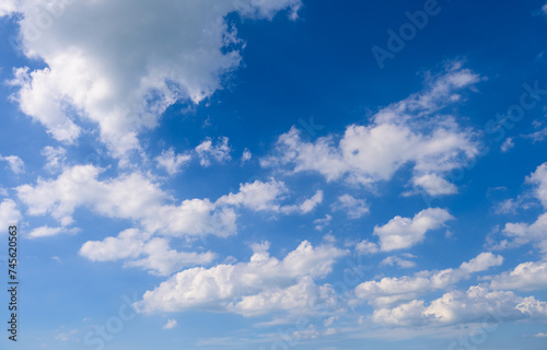Blue sky nature background with fluffy white clouds