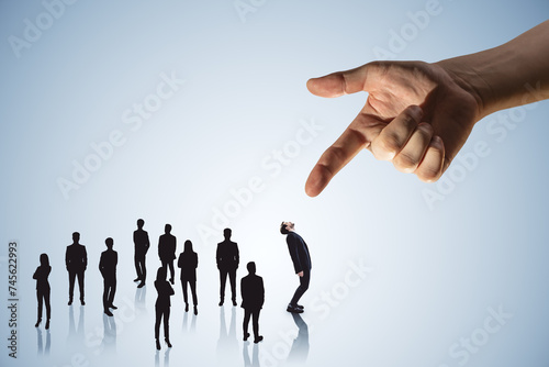 Hand pointing at crowd of businessmen on light wallpaper. Worker management concept. photo