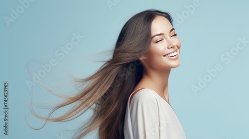 Portrait of a beautiful, sexy happy smiling woman with perfect skin and long hair, on a light blue background, banner.