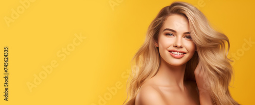 Portrait of a beautiful  sexy Caucasian woman with perfect skin and white long hair  on a yellow background.