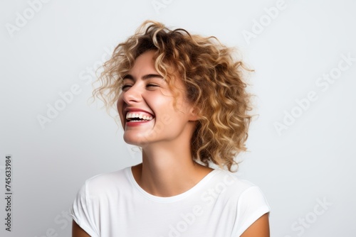Portrait of a happy young woman with curly hair on white background © Iigo