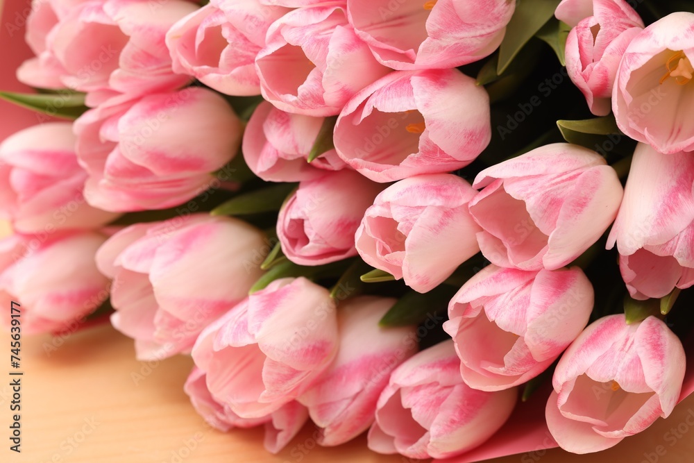 Beautiful bouquet of fresh pink tulips on table, closeup