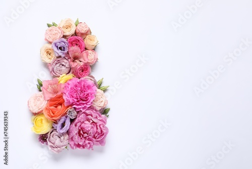 8 March greeting card design made with beautiful flowers on white background, top view