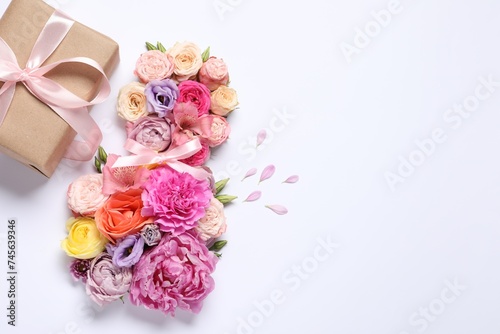 8 March greeting card design made with beautiful flowers and gift box on white background, top view. Space for text