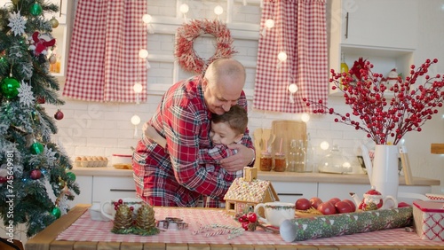 Senior man and his grandchildren together at the kitchen on Christmas holidays