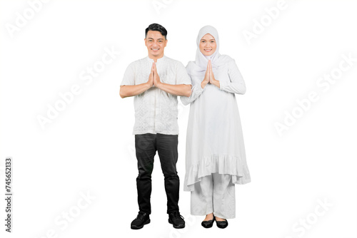 Muslim family of two adults showing greetings gesture