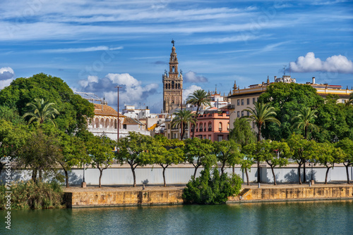 Spain, Andalusia, Seville,Riverside promenade with Giralda bell tower in background photo
