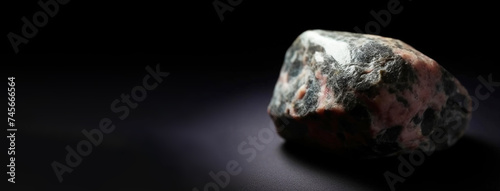 Eveite is a rare precious natural stone on a black background. AI generated. Header banner mockup with space.