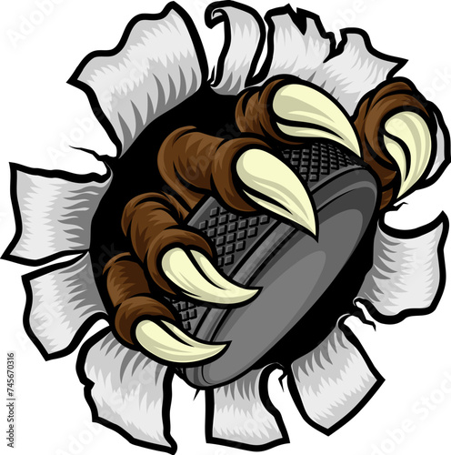 An ice hockey claw sports illustration of an eagle or animal monster hand holding a hockey puck