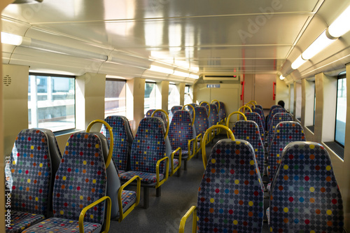 Interior of subway train with empty seats photo