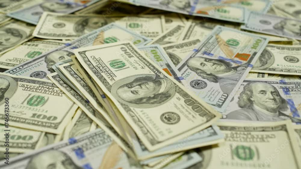 A large number of old and new dollars are laid out on the table. Someone throws first one wad of money into the center, then another. High quality 4k footage A large number of old and new dollars are laid out on the table. Someone throws first one wad of money into the center, then another. High quality 4k footage
