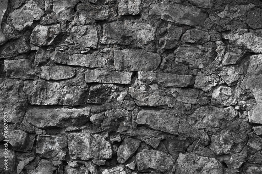 Obraz premium in the photo there is an old gray stone wall close up