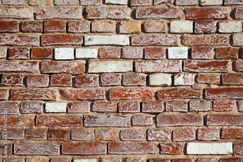 in the photo there is a close-up of an old brick wall