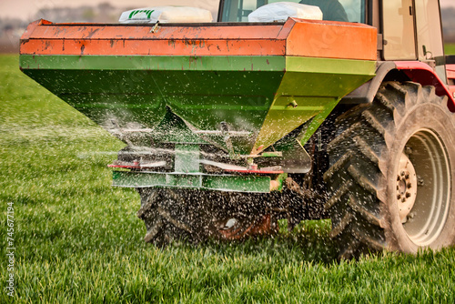 Crop sprayer spraying fertilizer on field