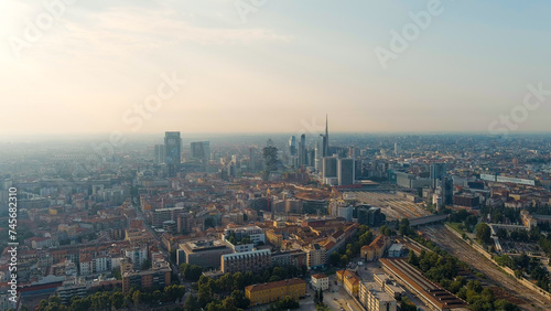 Milan, Italy - July 15, 2023: The famous skyscrapers of Milan are located around the botanical garden Campo di Fiori BAM. Milano Porta Garibaldi train station, Aerial View