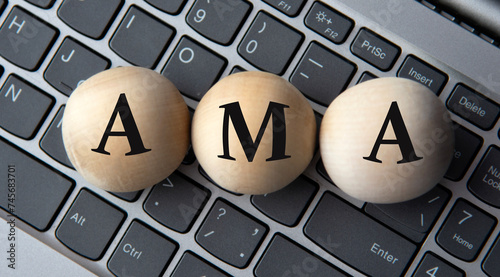 AMA - acronym on wooden balls on laptop keyboard background photo