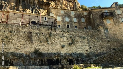 Monastery built into the side of a mountain. Pustinja Blaca Monastery. Blaca Hermitage. Religion. Brac Island, Croatia. Europe. photo