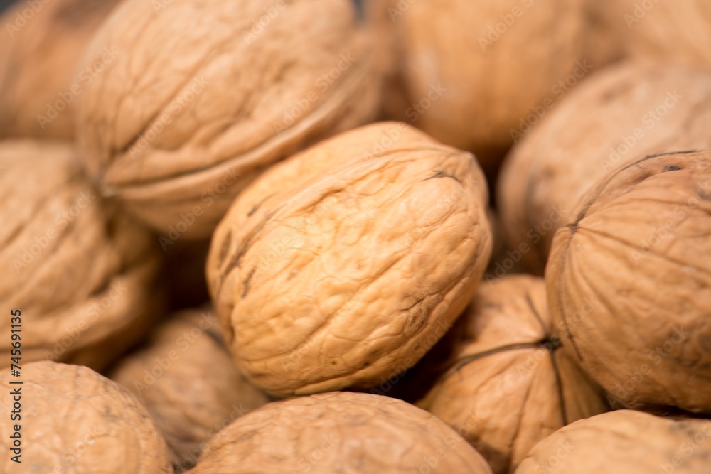 Nature's Bounty: A Close-Up of Fresh, Organic Walnuts, This image features a close-up view of fresh, organic walnuts. Each nut, encased in its shell, showcases intricate textures and rich Nature's Bounty: A Close-Up of Fresh, Organic Walnuts, This image features a close-up view of fresh, organic walnuts. Each nut, encased in its shell, showcases intricate textures and rich