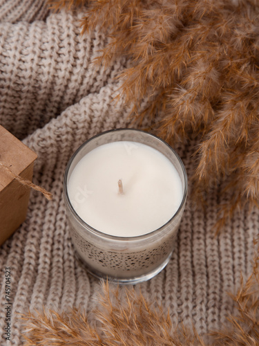 warm cozy candles on a beige wool background