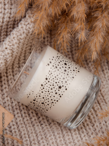 warm cozy candles on a beige wool background