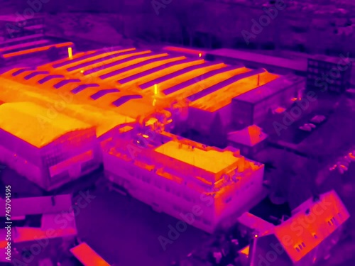 Aerial infrared thermal view of industrial zone with factories and warehouses, in purple and yellow hues
 photo