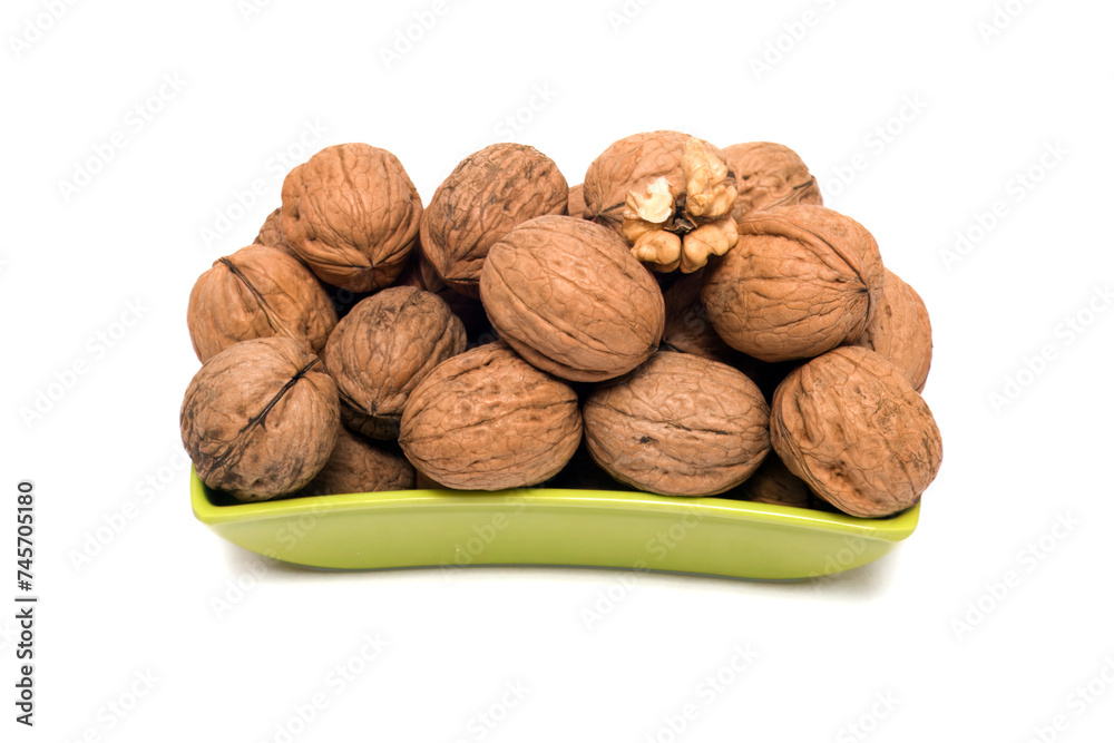 Fresh, Uncracked Walnuts Nestled in a Vibrant Green Bowl, This image beautifully captures fresh, uncracked walnuts nestled in a sleek, vibrant green bowl. The earthy brown tones of the walnuts Fresh, Uncracked Walnuts Nestled in a Vibrant Green Bowl, This image beautifully captures fresh, uncracked walnuts nestled in a sleek, vibrant green bowl. The earthy brown tones of the walnuts