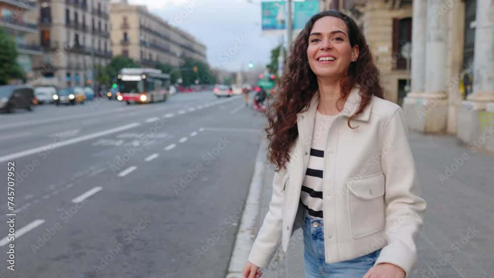Young beautiful woman with travel luggage looking for a taxi in Barcelona city. Travel and private transportation concept. Young beautiful woman with travel luggage looking for a taxi in Barcelona city. Travel and private transportation concept.