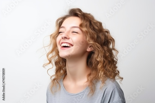 Portrait of a happy young woman with long wavy blond hair