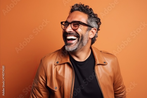 Portrait of a smiling Indian man in a leather jacket and sunglasses