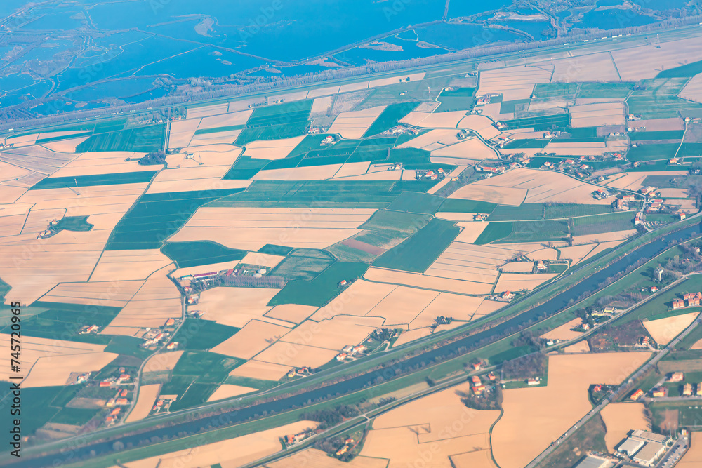 Aerial view of agricultural fields and farmlands. Shot in flight over the countryside.