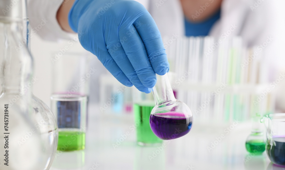 Fototapeta premium A male chemist holds test tube of glass