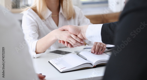 Businessman and woman shake hands