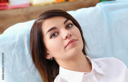 A woman at the reception of a male dentist examining