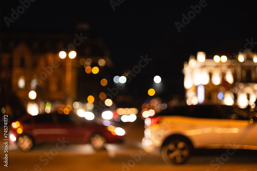 Night traffic in the city. Blurred background of night city lights.