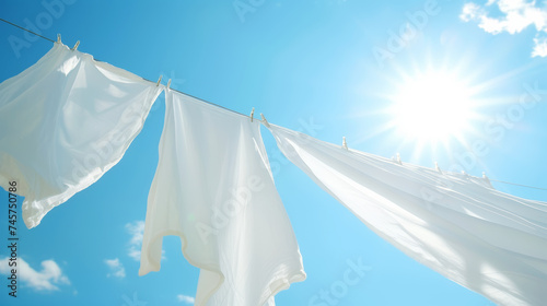 White sheets dry on a clothesline against the background of a blue sunny sky. Laundry day concept. Generative AI