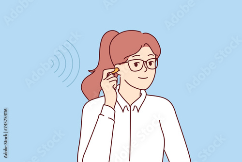 Businesswoman uses earplugs to get rid of noise that reduces concentration and productivity. Girl holds wireless headphones for listening to music or hearing aid that allows to restore hearing.