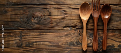 Close up traditional wooden spoon and fork on wooden table. Generated AI image