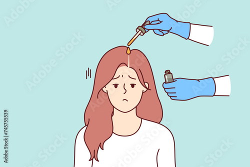 Fighting lice on head of girl sadly attending procedure of applying medicinal ointment for pediculosis to hair. Woman suffering from pediculosis causing itching and hair loss, near hands of doctor