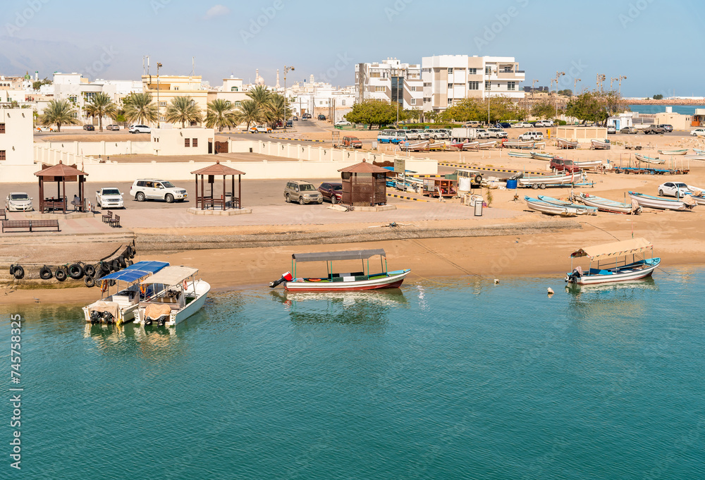 View of the port with typical boats in Sur city, Sultanate of Oman in the Middle East.