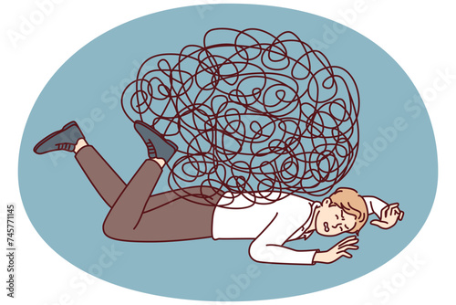 Depressed businessman lies on ground face down under heavy load of tangled lines. Guy in office clothes is tired of fighting because of stress at work and frequent overload