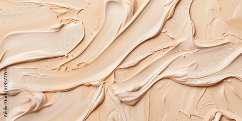 Liquid foundation strokes on nude color background.