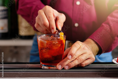 Bartender garnishing a cocktail at the bar