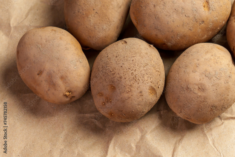 Fresh vegetable potatoes on a brown crumpled wrapping paper Fresh vegetable potatoes on a brown crumpled wrapping paper