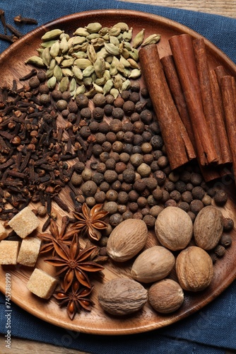 Different spices and nuts on table, top view