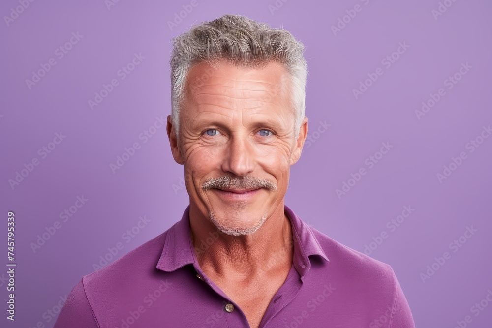 Portrait of handsome mature man. Isolated on violet background. Portrait of handsome mature man. Isolated on violet background.
