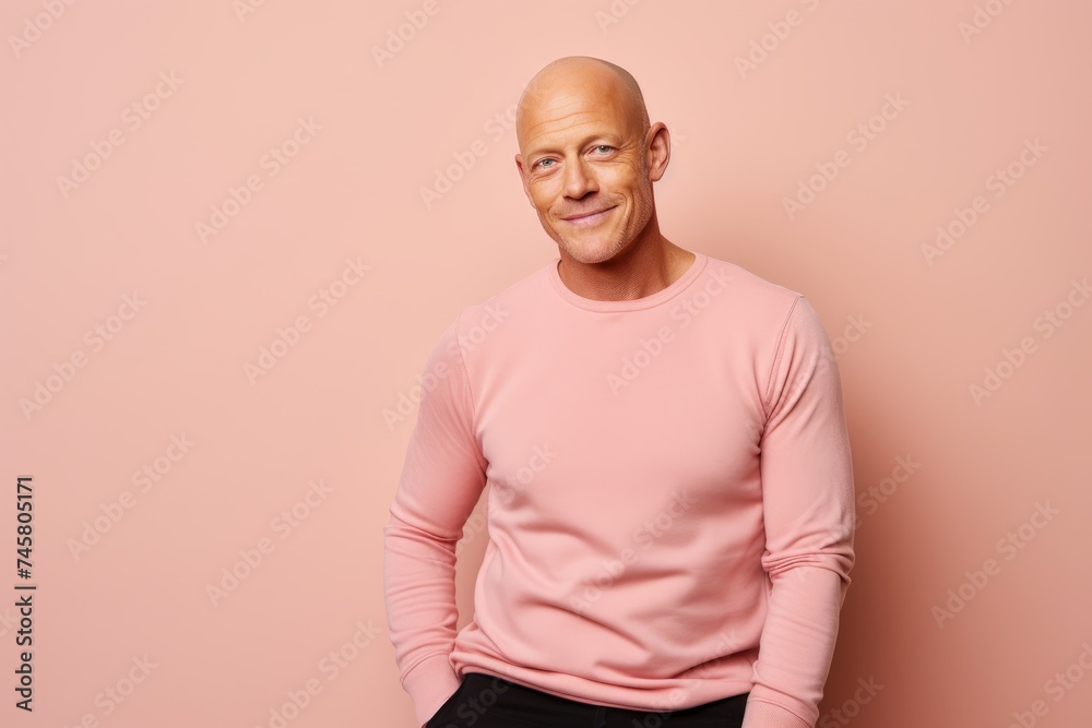 Portrait of a smiling bald man in a pink sweatshirt. Portrait of a smiling bald man in a pink sweatshirt.