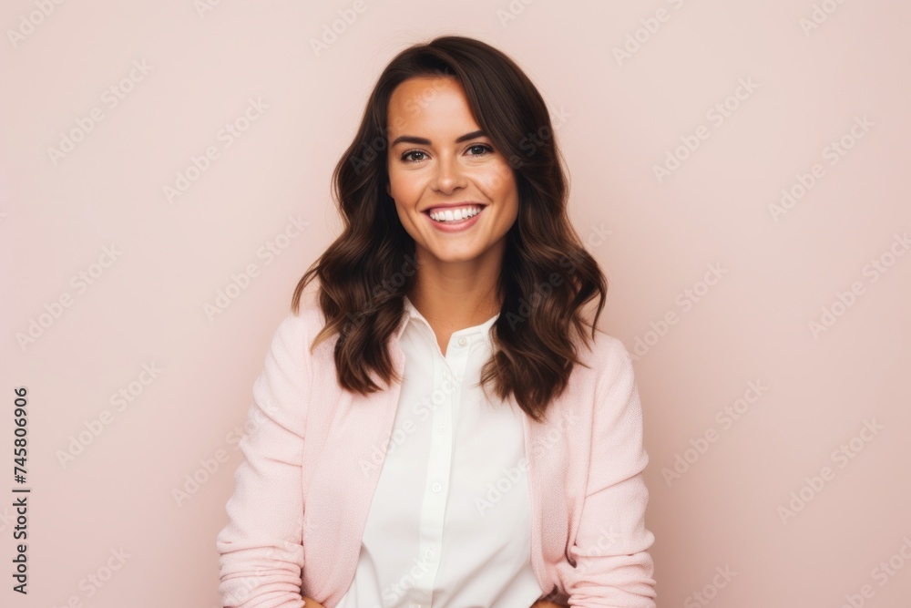 Portrait of a happy young business woman standing against pink background. Portrait of a happy young business woman standing against pink background.