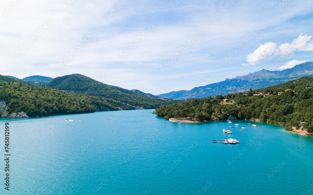 Aerial photo by drone of the Chanteloube bridge drowned in the turquoise waters of the Serre-Ponçon lake, located in the Hautes-Alpes, in France